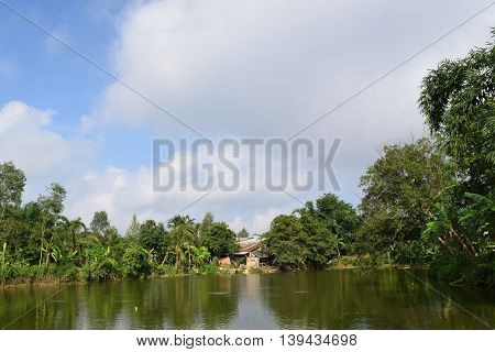 Vietnamese countryside with house next to the fishing pond