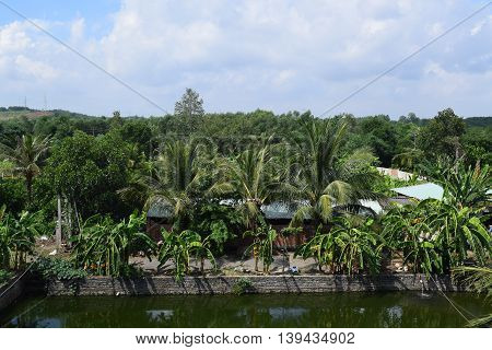 Vietnamese countryside with house next to the fishing pond