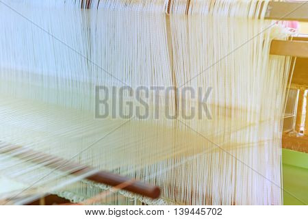 Weaving loom and shuttle on the warp.
