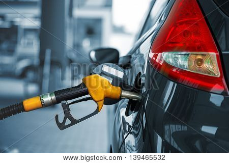 Car refueling on a petrol station closeup