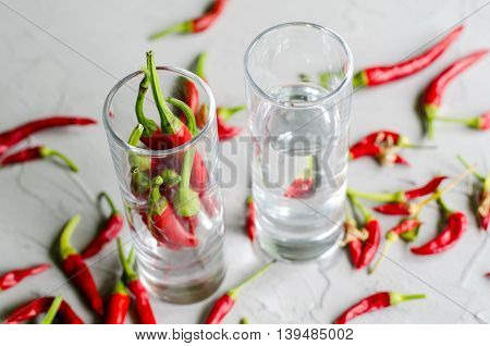 Shots with vodka and chilly peppers hot alcoholic drink