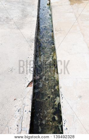A Dirty sewage in the drainage trough.