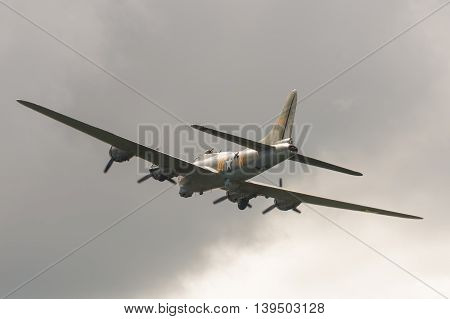 FARNBOROUGH, UK - JULY 17: Vintage Boeing B-17 Flying Fortress bomber in cloudy skies over Farnborough, UK on July 17, 2016