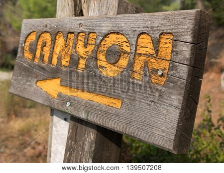eco tourism old road sign. canyon text and arrow.