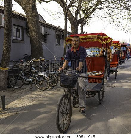 Beijing China April 3 2016 Pedicab drivers lined up waiting for fares in Beijing