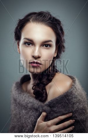 Fashion portrait of gorgeous young brunetee woman.Chaos hair style with braid. Shallow depth of field
