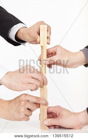 Hands Of Business Group Building By Wooden Block