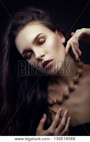 Fashion portrait of gorgeous young brunetee woman. Shallow depth of field. Chaos on head hairstyle