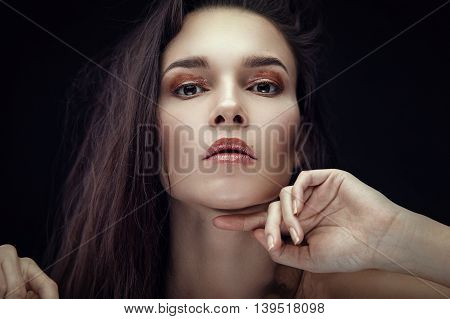 Fashion portrait of gorgeous young brunetee woman. Shallow depth of field. Chaos on head hairstyle