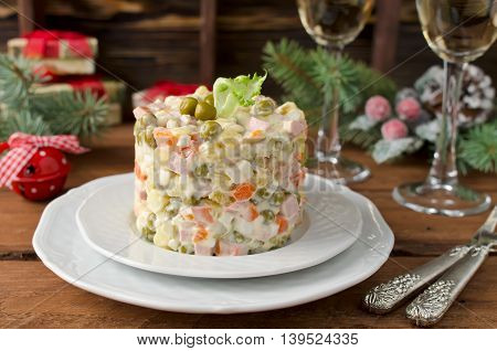 Russian traditional salad Olivier with vegetables and meat. Winter Christmas salad