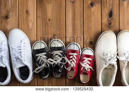 Sneakers of family placed on the wood table