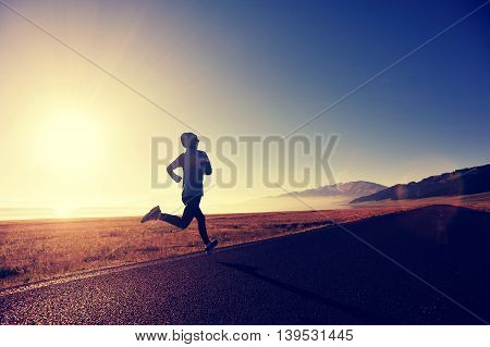healthy young fitness woman runner running on sunrise seaside trail