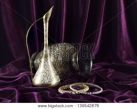 Vintage ethnic vases with circlets on velvet background