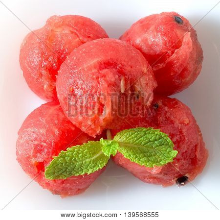 Fresh Fruits Ripe and Sweet of Refreshing Watermelon Decorated with Mint Leaves on A White Plate.