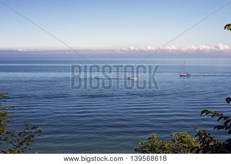 View over Oeresund with two sailboats - Dronningmoelle Denmark