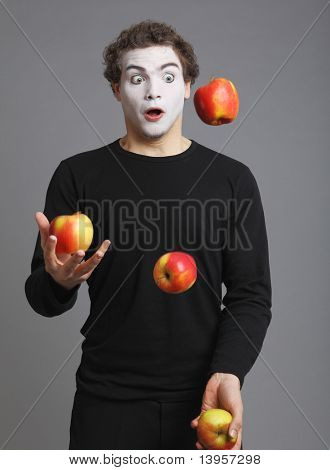 Retrato de Mime con manzana roja sobre fondo gris