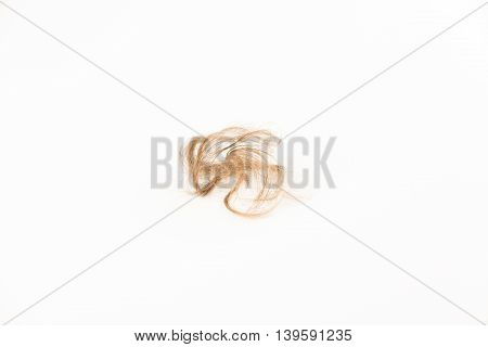 Close-up of hair loss, long hair, alopecia on white background with brush, comb nobody