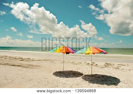 Two Beach Umbrellas on the Sandy Coastline of Anna Maria Island