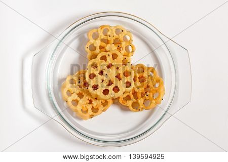 Achappam on a transparent glass plate :- a Traditional Sweet or Snack in Kerala, India, made during festivals with main ingredients Rice and Egg and fried in coconut oil using a mold.