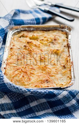 Parmentier casserole in a blue a towel.