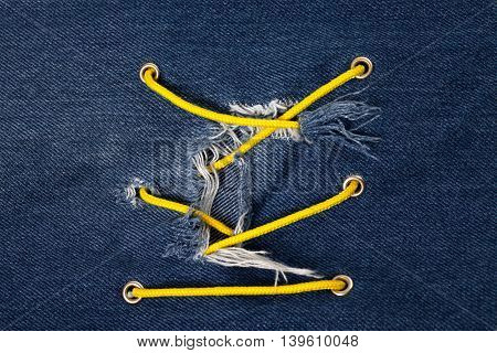 Blue jean with hole and crisscross lacing