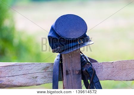 US Civil War Federal Army's Soldiers Cap is balanced on a fence post.