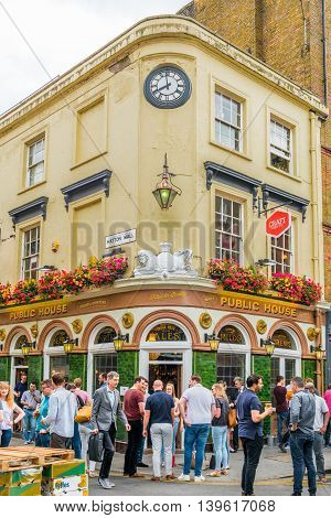 London United Kingdom - July 22 2016: Pub at Leather Lane Street Market - street in Holborn with great streetfood fruit and vegetables and clothes stalls very popular with office workers Monday to Friday