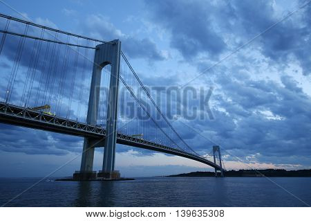 NEW YORK - JULY 23, 2016: Verrazano Bridge at dusk in New York.The Verrazano Bridge is a double-decked suspension bridge that connects the boroughs of Staten Island and Brooklyn