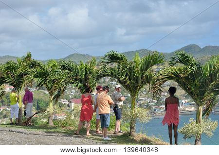 DENNERY ST LUCIA CARIBBEAN 19 January 2015: Tourists looking over small Caribbean Town