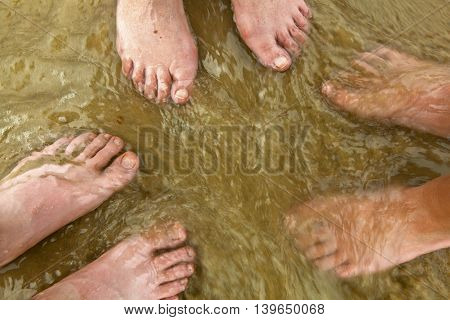 Feet Of Family At The Beach