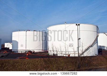 White Tanks In Tank Farm With Blue Sky