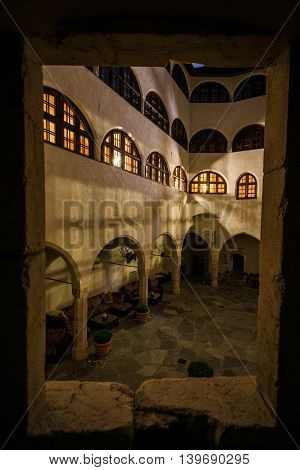 Looking Through Stone Window of Castle Matzen over Modern Medieval Courtyard