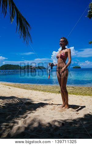 Photo young girl relaxing on beach snorkeling equipment. Smiling woman spending chill time outdoor summer Bali island. Horizontal picture