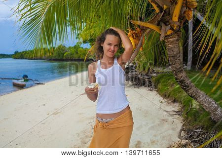 Photo young girl relaxing on beach with flowers. Smiling woman spending chill time outdoor Bali island. Summer Season Caribbean Ocean. Horizontal picture