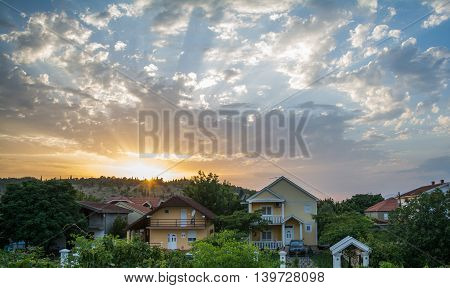 Neighbourhood houses in beautiful colorful cloudy sunset