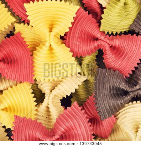 raw bow-knot pasta of different color, background