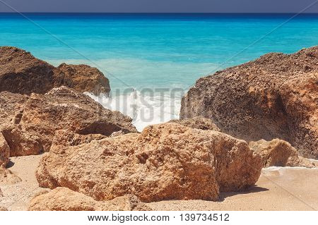 Kavalikefta  beach,  Lefkada island, Greece. Rocky beach and clear turquoise blue sea on a sunny summer day, close up. Vintage toned image