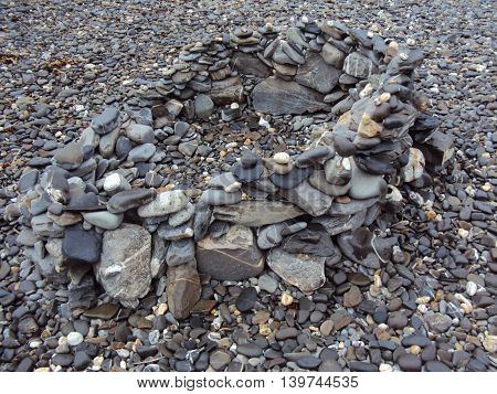 Stone pile upon beach photographed at Crackington Haven in Cornwall