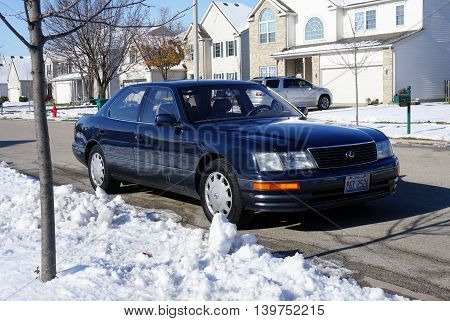 JOLIET, ILLINOIS / UNITED STATES - NOVEMBER 24, 2015: A blue Lexus LS-400 luxury sedan is parked in a residential area of Joliet after a November snowstorm.