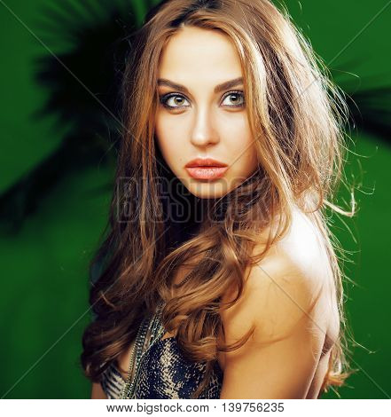 young cute blonde woman on green palm background smiling happy, lifestyle peole concept close up