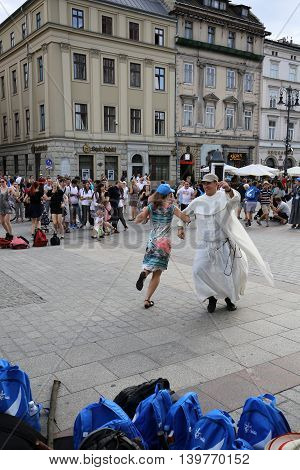 CRACOW POLAND - JULY 24 2016: Pilgrims of World Youth Day sing and dance on the Main Square in Cracow. Poland