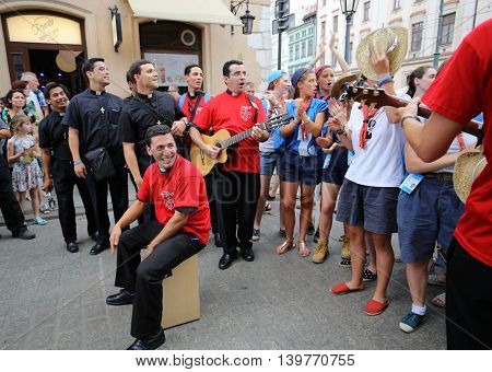 CRACOW POLAND - JULY 24 2016: Pilgrims of World Youth Day sing and dance on the Main Square in Cracow. Poland