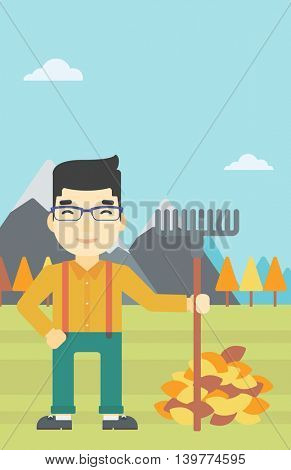 An asian young man raking autumn leaves. Man with rake standing near tree and heap of autumn leaves. Man tidying autumn leaves in garden. Vector flat design illustration. Vertical layout.