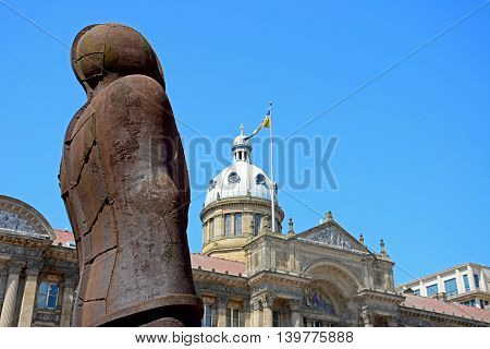 BIRMINGHAM, UNITED KINGDOM - JUNE 6, 2016 - The Iron Man statue by Antony Gormley in Victoria Square with the Town Hall to the rear Birmingham England UK Western Europe, June 6, 2016.