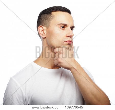 Portrait of handsome young thoughtful man isolated over white ba