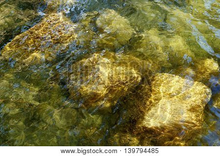 a shot of rocks submerged in water.