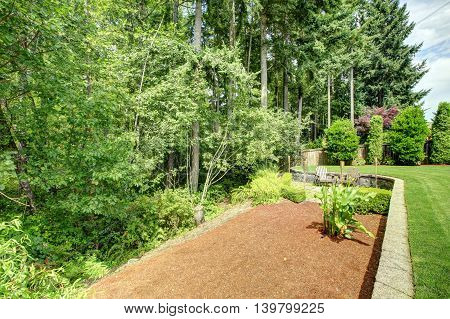 Backyard Landscape With Flower Bed
