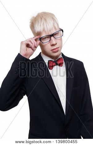 Albino young man portrait. Blond guy in suit with red bow tie isolated at white background. Albinism, pale skin. Stylish young boy in eye glasses and suit.