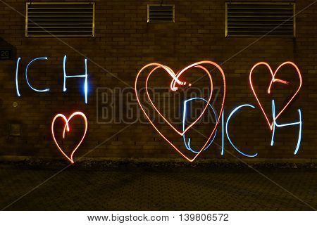 Declaration of love with light at night outdoor with german words for i love you