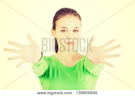 Attractive  woman with hands open in front oh her.